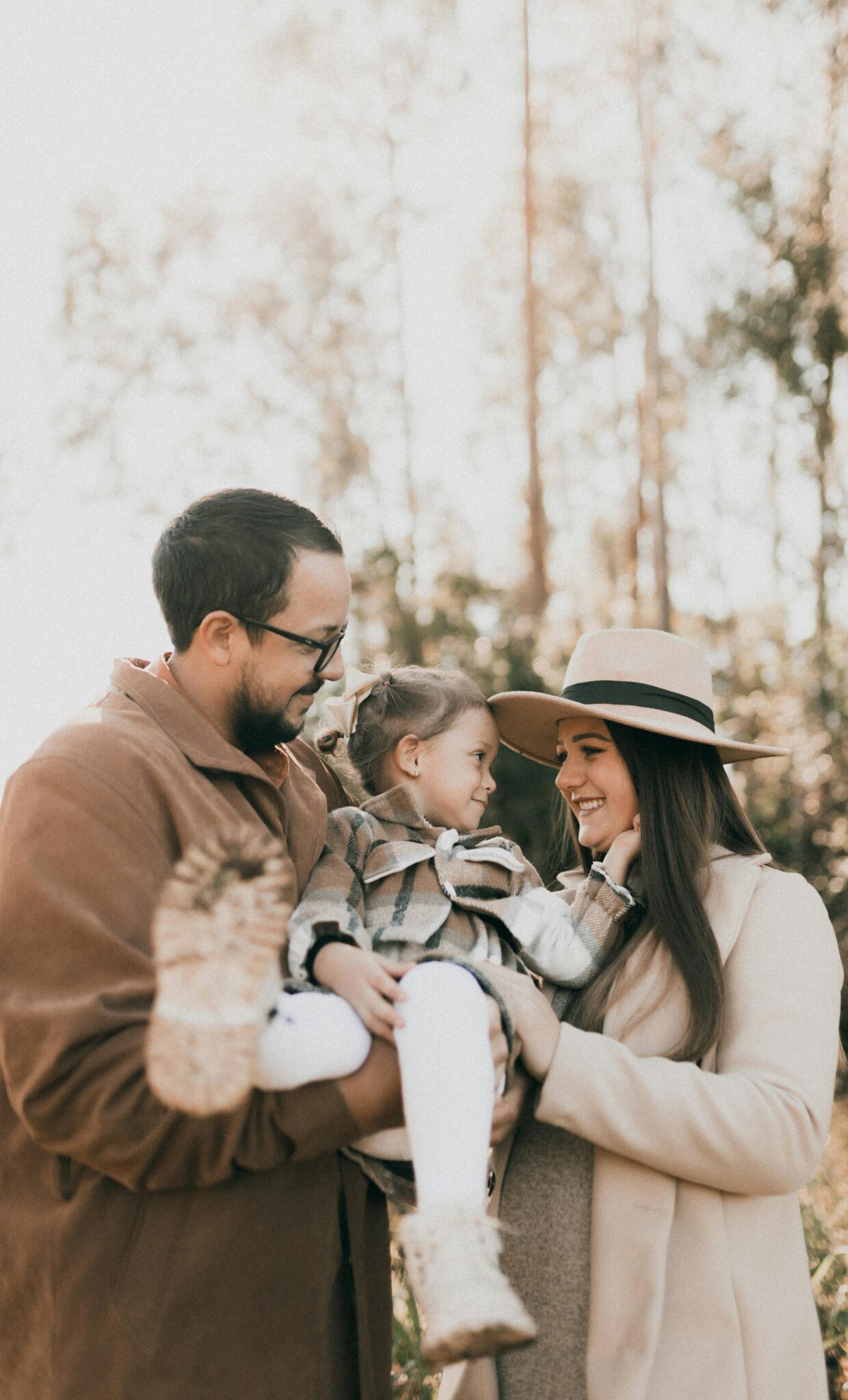Parents and daughter in camel and cream fall outfits