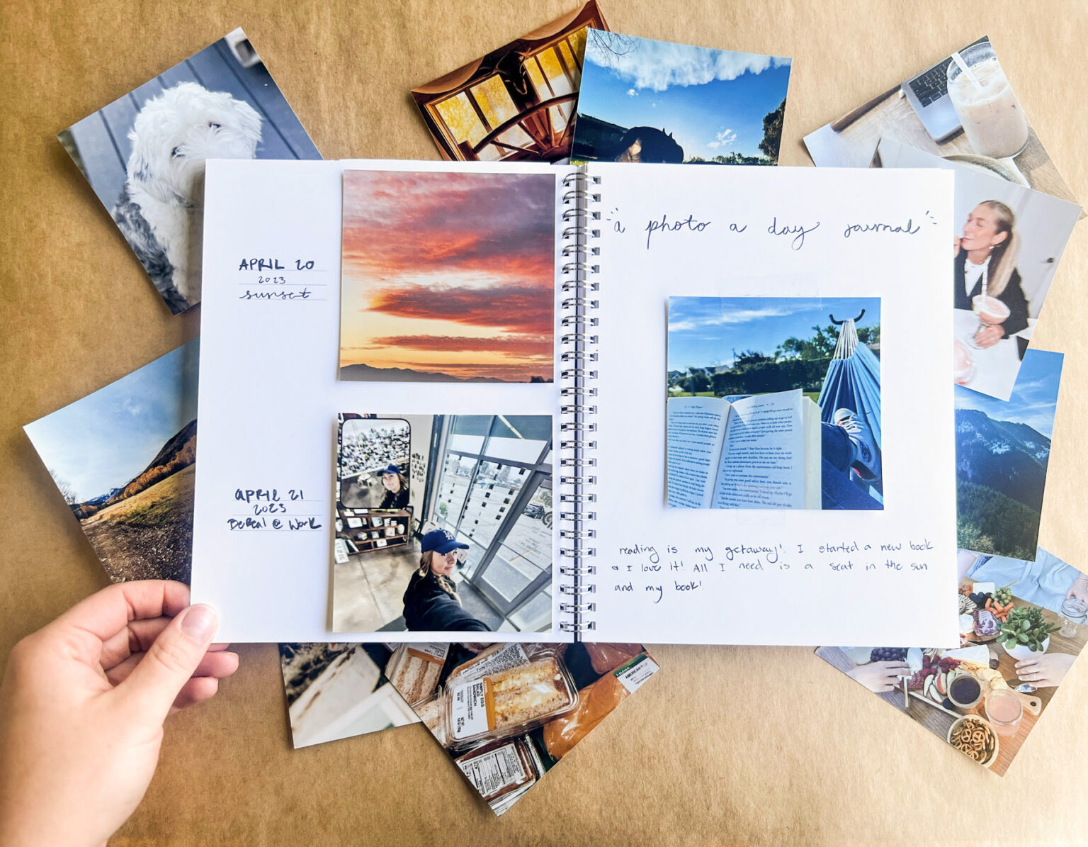 Open journal spread filled with mini photo prints and handwritten notes