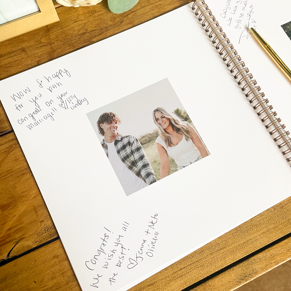 Wedding guest book and photo prints on a welcome table