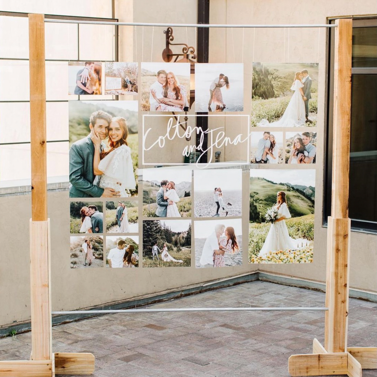 Large wedding prints hanging from a standing display frame