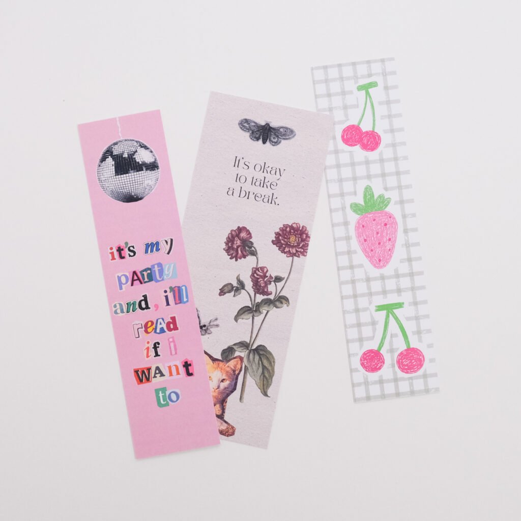 Three custom bookmarks with a quote, flowers, and cherries